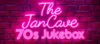 Pink neon sign reading The JanCave 70s Jukebox against a purple brick wall