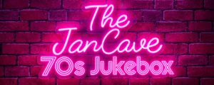 Pink neon sign reading The JanCave 70s Jukebox against a purple brick wall